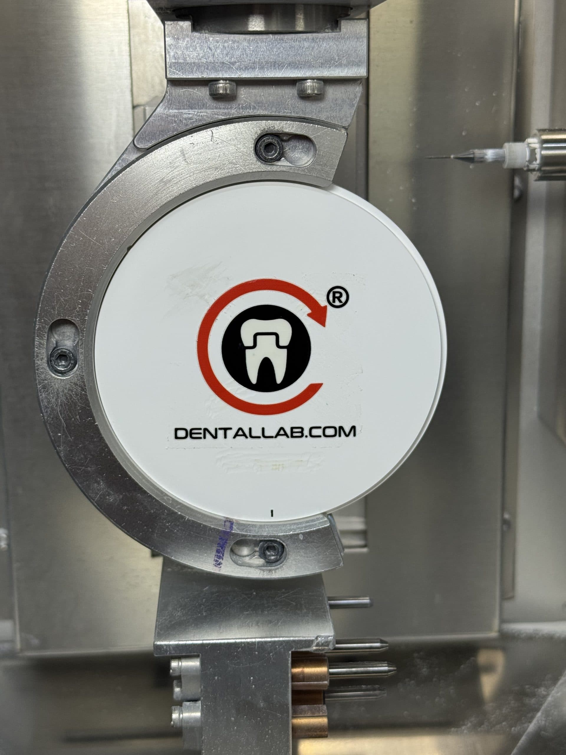 CAD/CAM dental milling machine with a mounted material disc and milling tool in a digital dentistry workflow